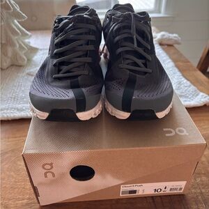 On Running Black Athletic Shoes with Lace-Up Design.